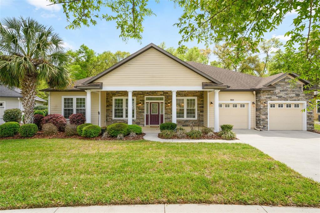 7971 Southwest 80th Lane Gainesville, FL 32608 - Photo 1 of 1 a front view of a house with yard and green space