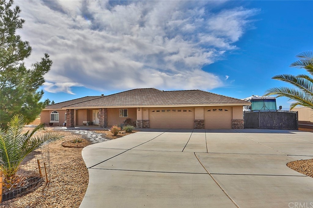 24075 Zuni Road Apple Valley, CA 92307 - Photo 1 of 1 a front view of a house with yard
