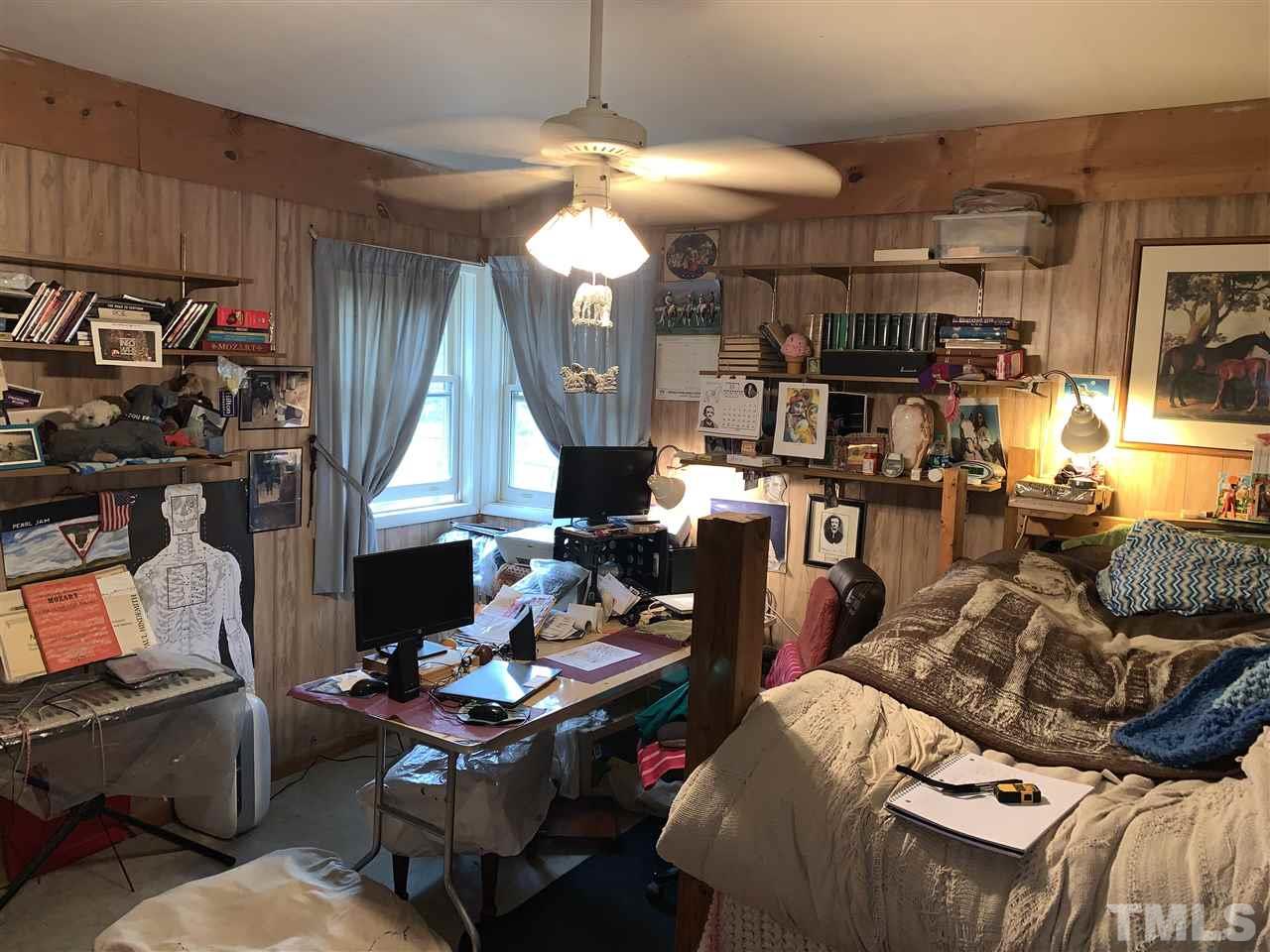 2425 Emerson Cook Road Pittsboro, NC 27312 - Photo 6 of 10 a living room with furniture and a chandelier
