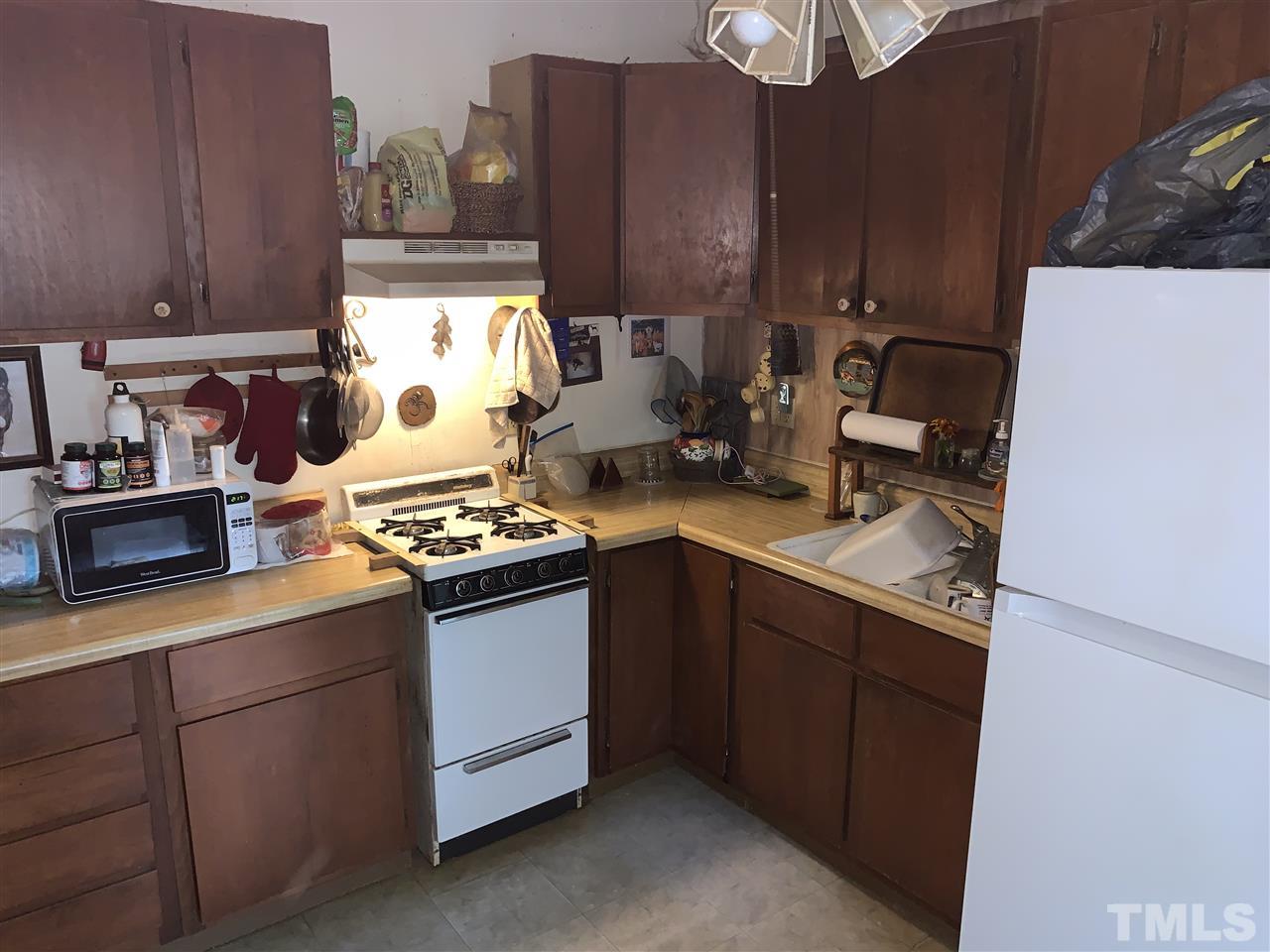 2425 Emerson Cook Road Pittsboro, NC 27312 - Photo 8 of 10 a kitchen with stainless steel appliances granite countertop a sink stove and cabinets