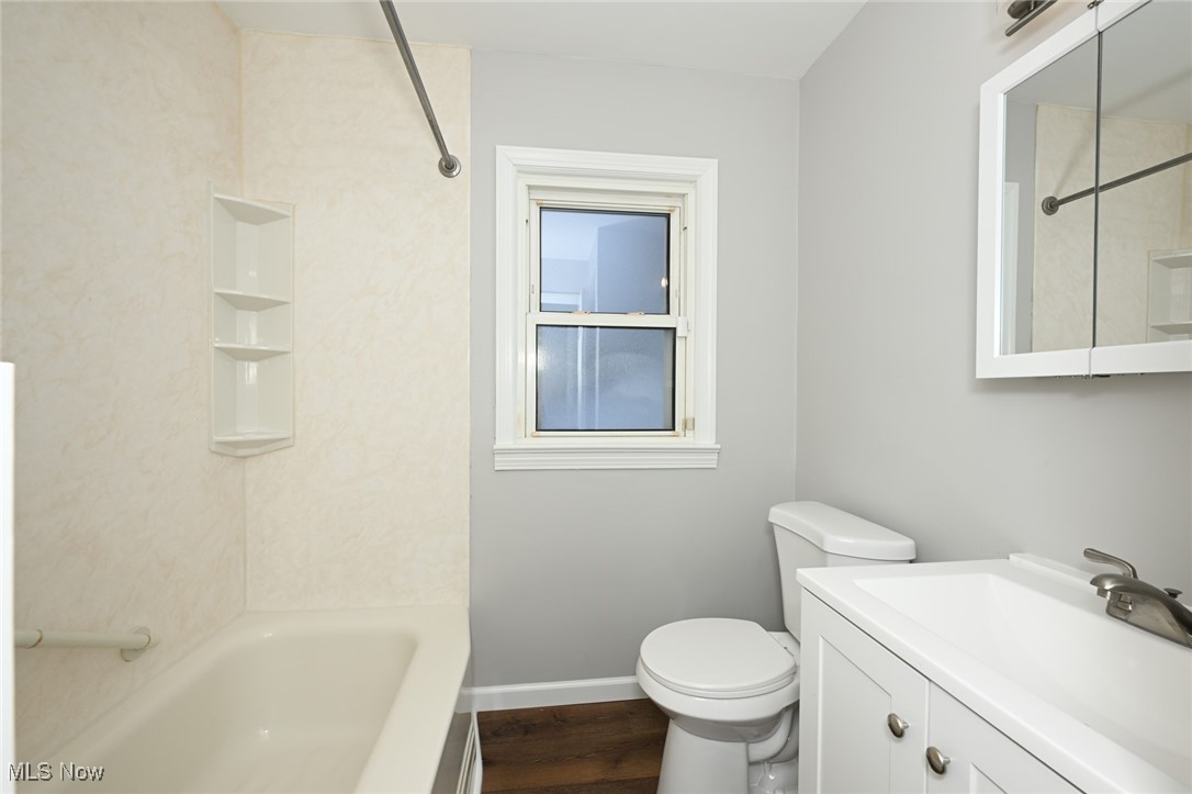 1571 Lander Road Cleveland, OH 44124 - Photo 10 of 39 Bathroom with vanity, bathing tub / shower combination, and dark wood-style floors