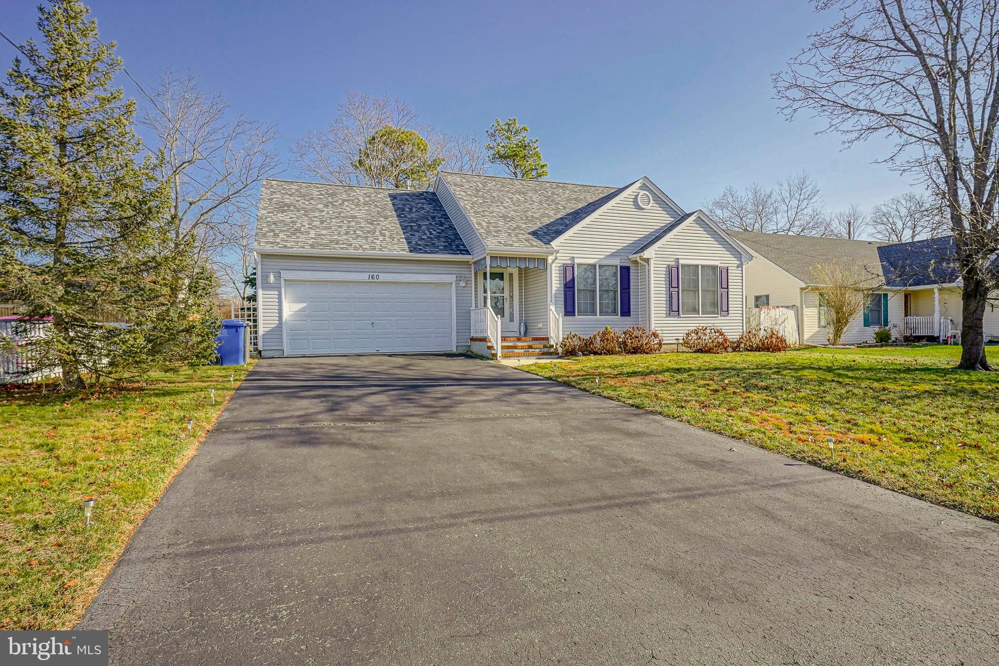 160 Gunwale Road Manahawkin, NJ 08050 - Photo 3 of 27 a front view of a house with a yard and trees
