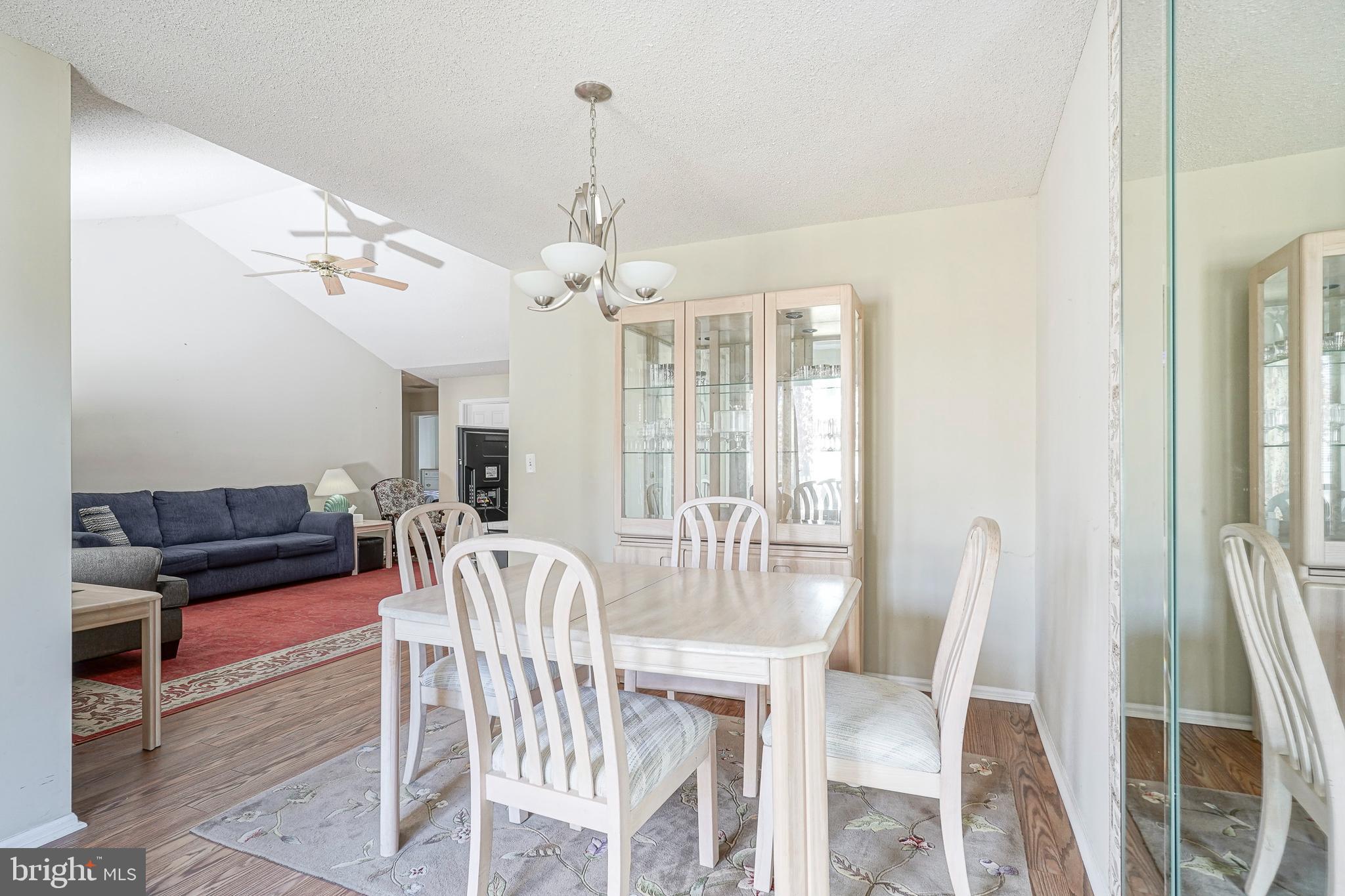 160 Gunwale Road Manahawkin, NJ 08050 - Photo 8 of 27 a view of a dining room with furniture wooden floor and chandelier