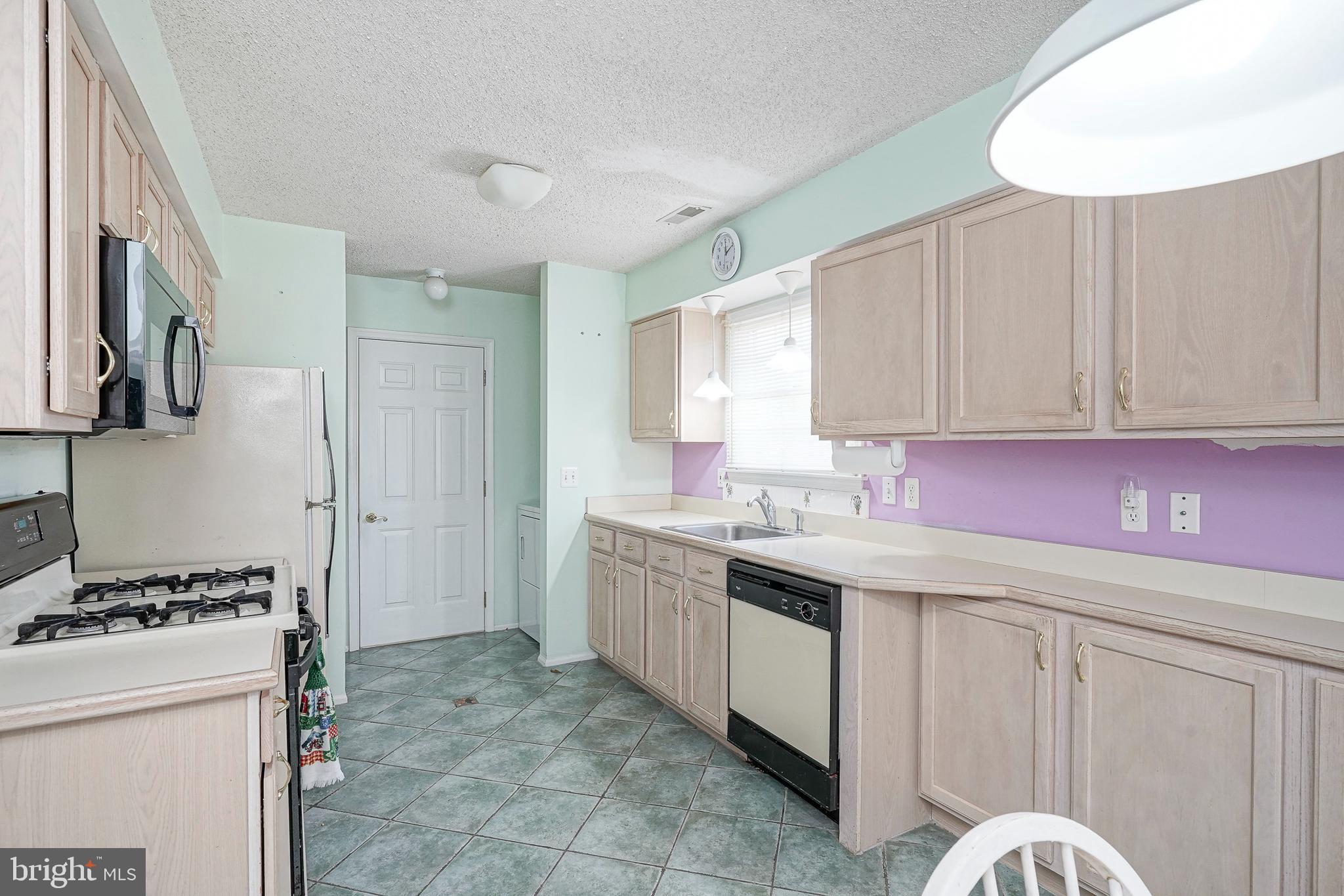 160 Gunwale Road Manahawkin, NJ 08050 - Photo 9 of 27 a kitchen with a sink stove and cabinets
