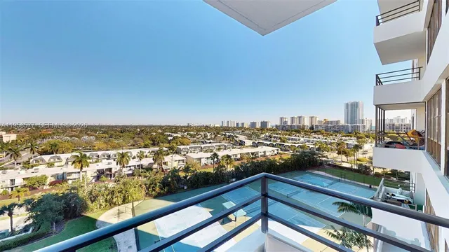 a bedroom with a bed and a walk in closet with wooden floor