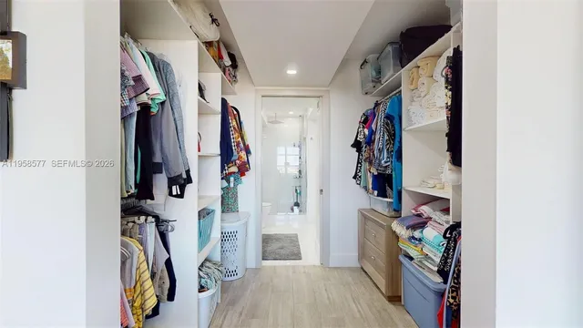 a bedroom with a bed and dresser with mirror