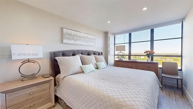 a view of swimming pool with outdoor seating and trees in the background