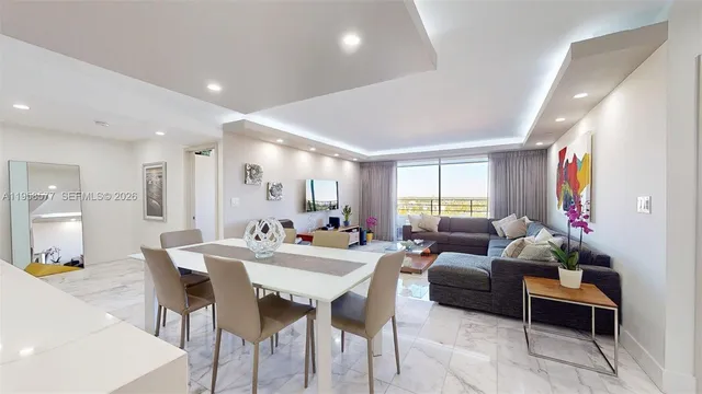 a large kitchen with kitchen island a sink a stove a dining table and chairs