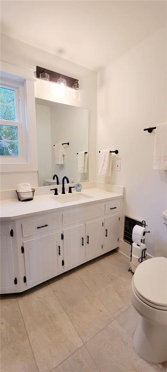 2900 Orchard Road Southwest Conyers, GA 30094 - Photo 18 of 63 a bathroom with a double vanity sink a toilet and a mirror