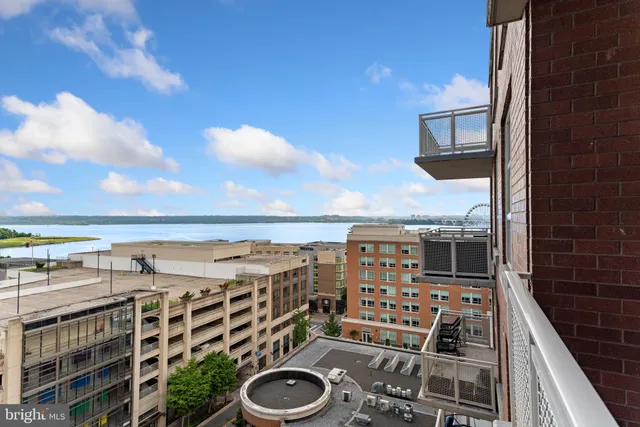 a view of a balcony with furniture and city view