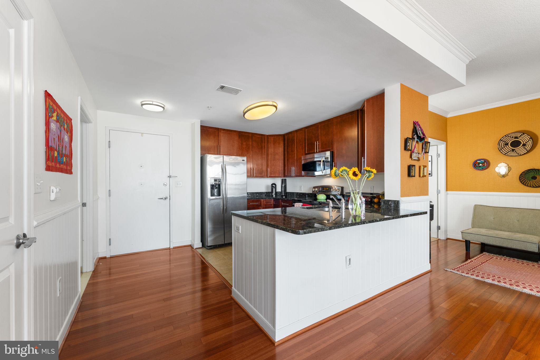 157 Fleet Street, Unit 1001 Oxon Hill, MD 20745 - Photo 5 of 24 a kitchen that has a lot of cabinets and wooden floor