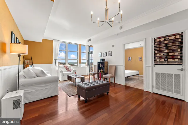 a living room with furniture dining table and a refrigerator