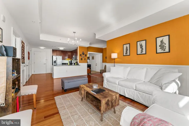 a living room with furniture and kitchen view
