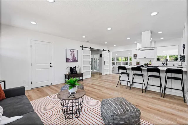 a living room with furniture and kitchen view