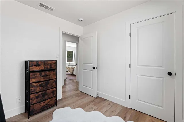 a view of walk in closet with empty racks