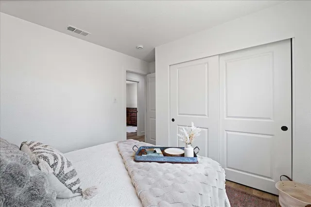 a bedroom with a bed and a mirror