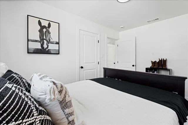 a bedroom with a bed and wall painting