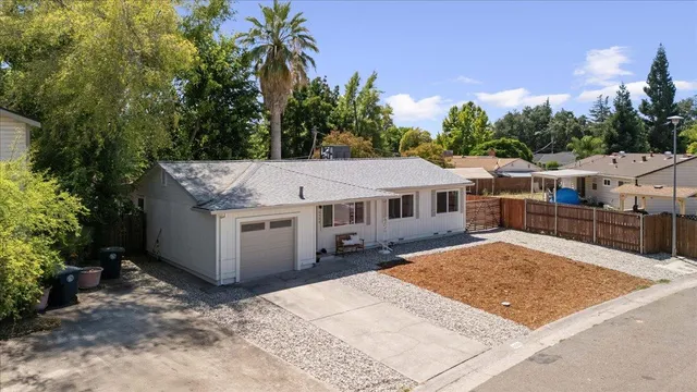 an aerial view of a house with a yard and garden