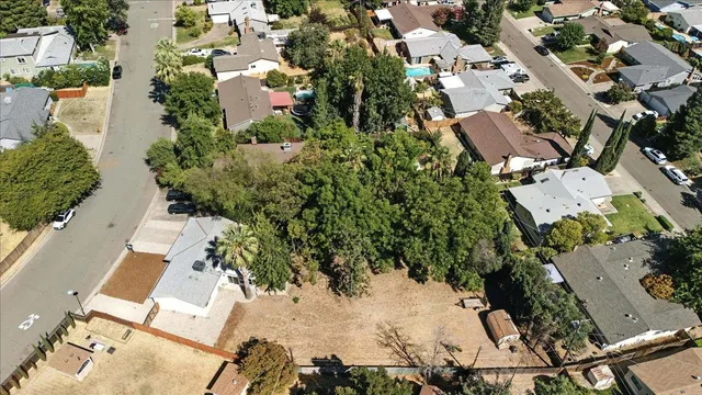 an aerial view of a house with a yard and lake view