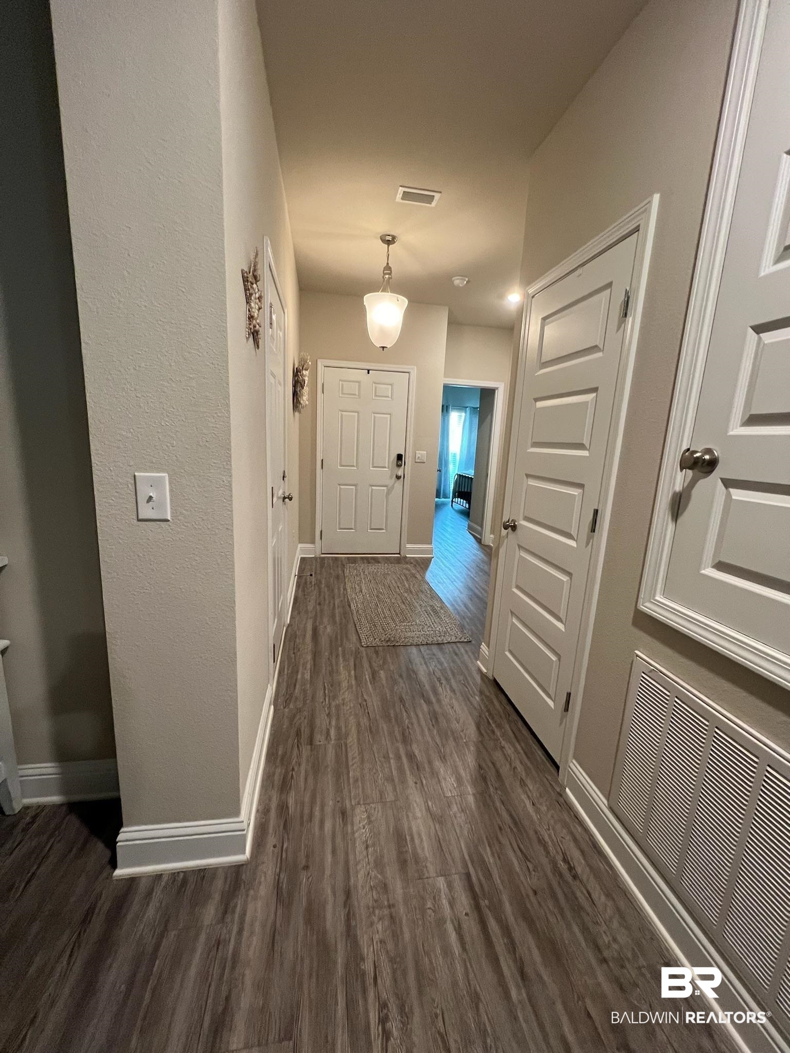 3904 Conrad Court Gulf Shores, AL 36542 - Photo 3 of 24 Corridor with dark hardwood / wood-style floors