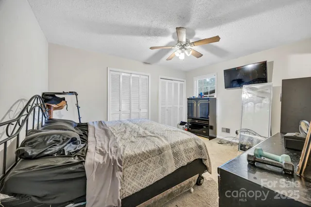 a bedroom with a bed and ceiling fan