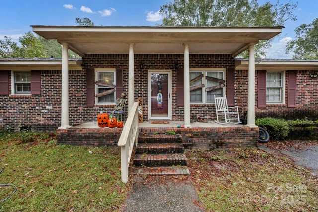 a living room with furniture ceiling fan and a wooden floor