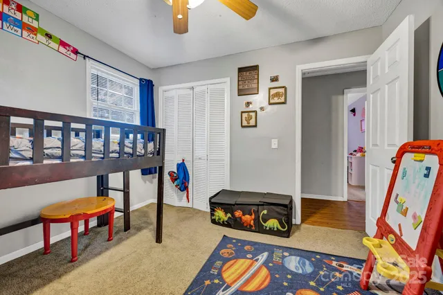a backyard of a house with barbeque oven table and chairs