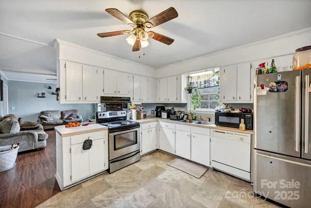 a kitchen with white cabinets and white appliances