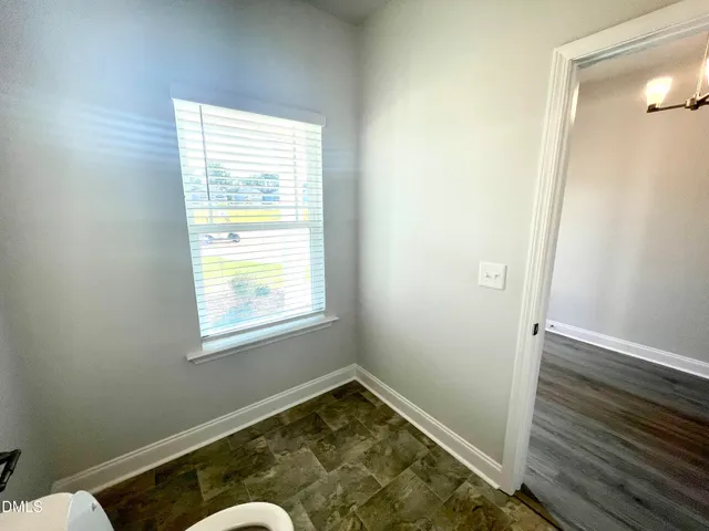 a view of a livingroom with a ceiling fan and window