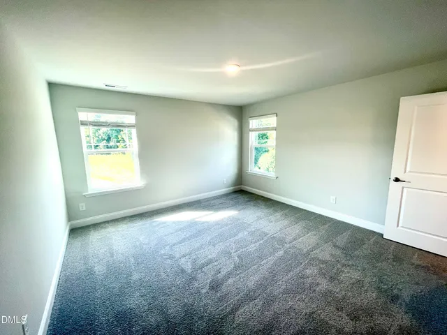 an empty room with a bathroom and a sink