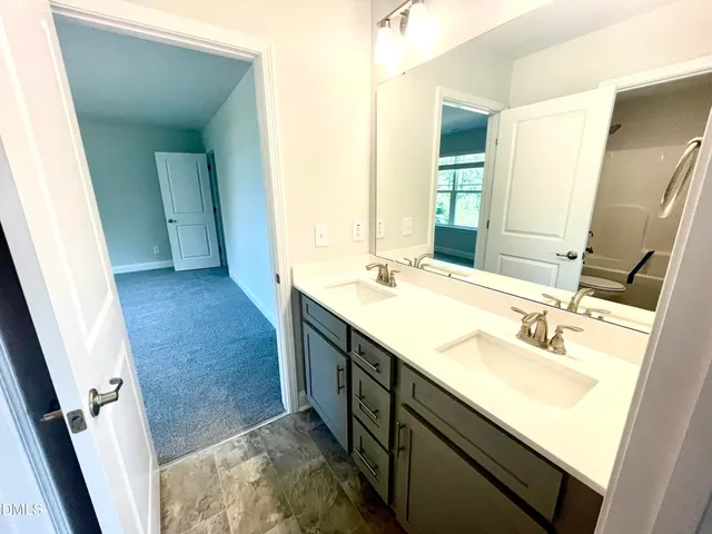 a white toilet sitting next to a bathroom sink and a shower