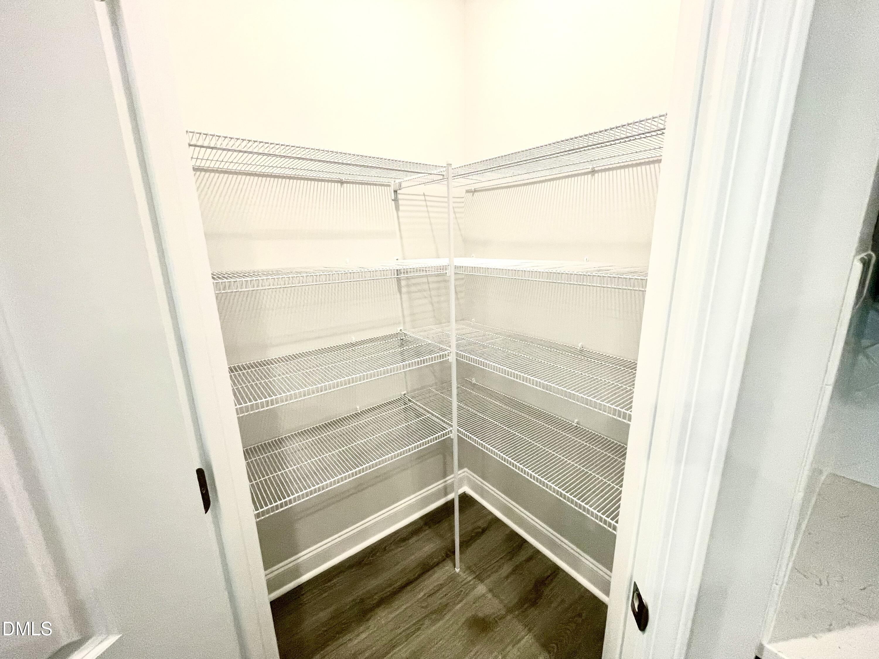 39 Deep Blue Trail Middlesex, NC 27557 - Photo 8 of 37 a view of walk in closet with empty racks