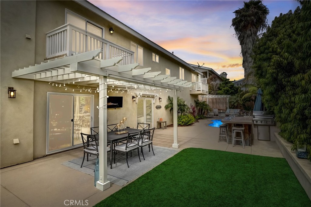 604 Hermes Avenue Encinitas, CA 92024 - Photo 1 of 1 a view of a patio with table and chairs potted plants and large tree