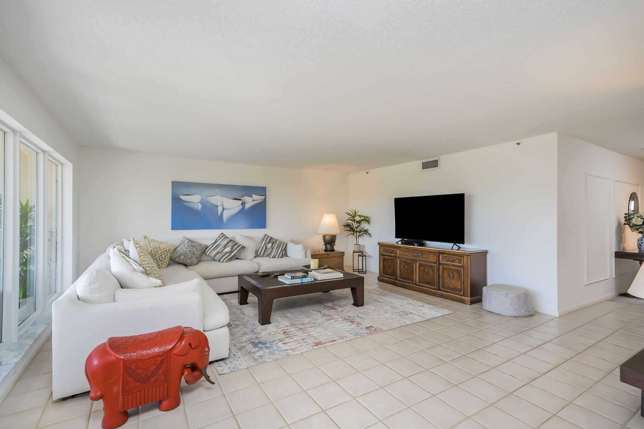 4301 North Ocean Boulevard, Unit A206 Boca Raton, FL 33431 - Photo 11 of 37 a living room with furniture and a flat screen tv