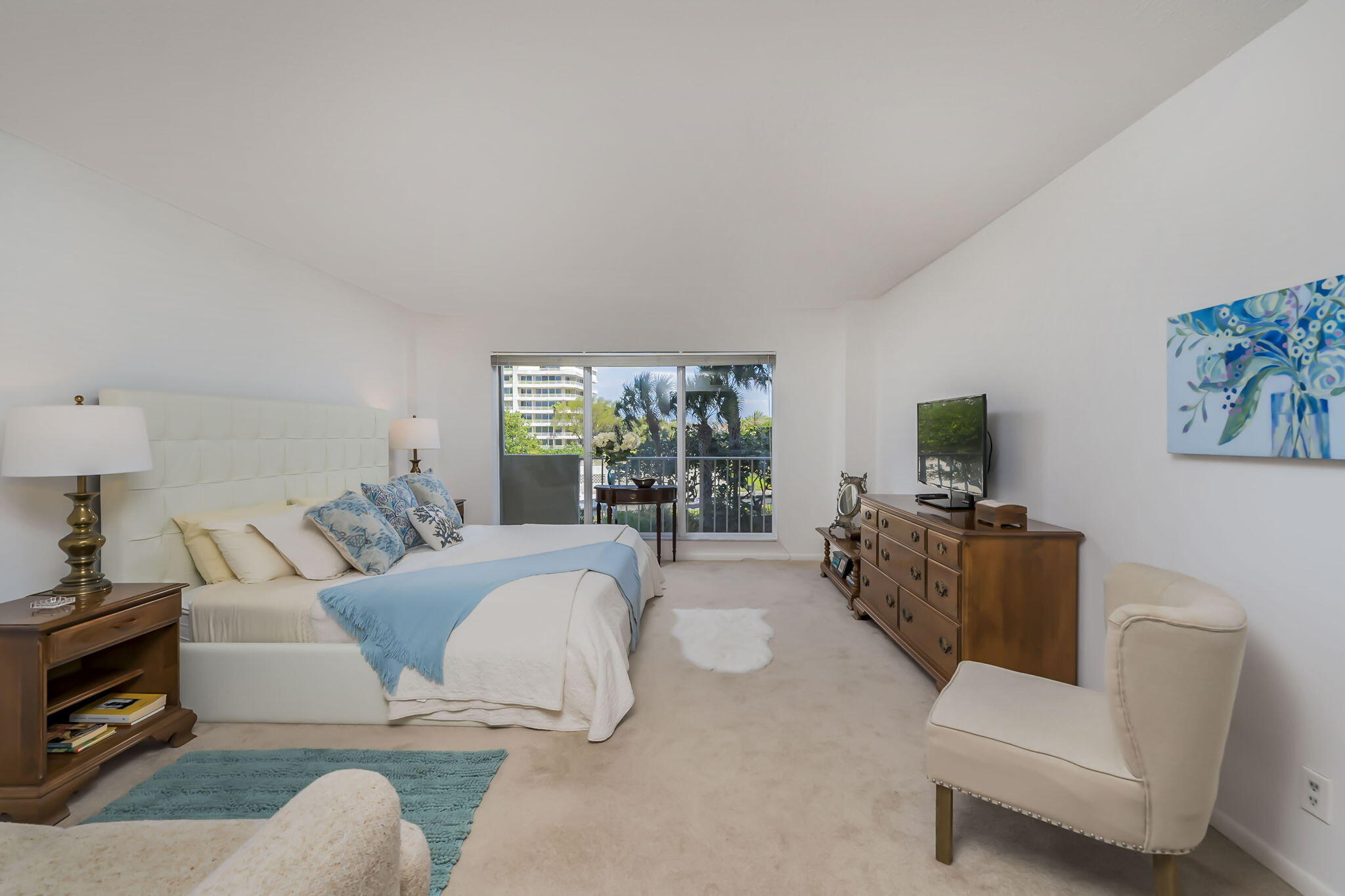 4301 North Ocean Boulevard, Unit A206 Boca Raton, FL 33431 - Photo 14 of 37 a living room with furniture and a flat screen tv