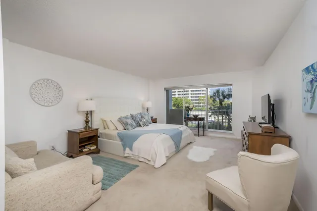 a living room with furniture a large window and a table