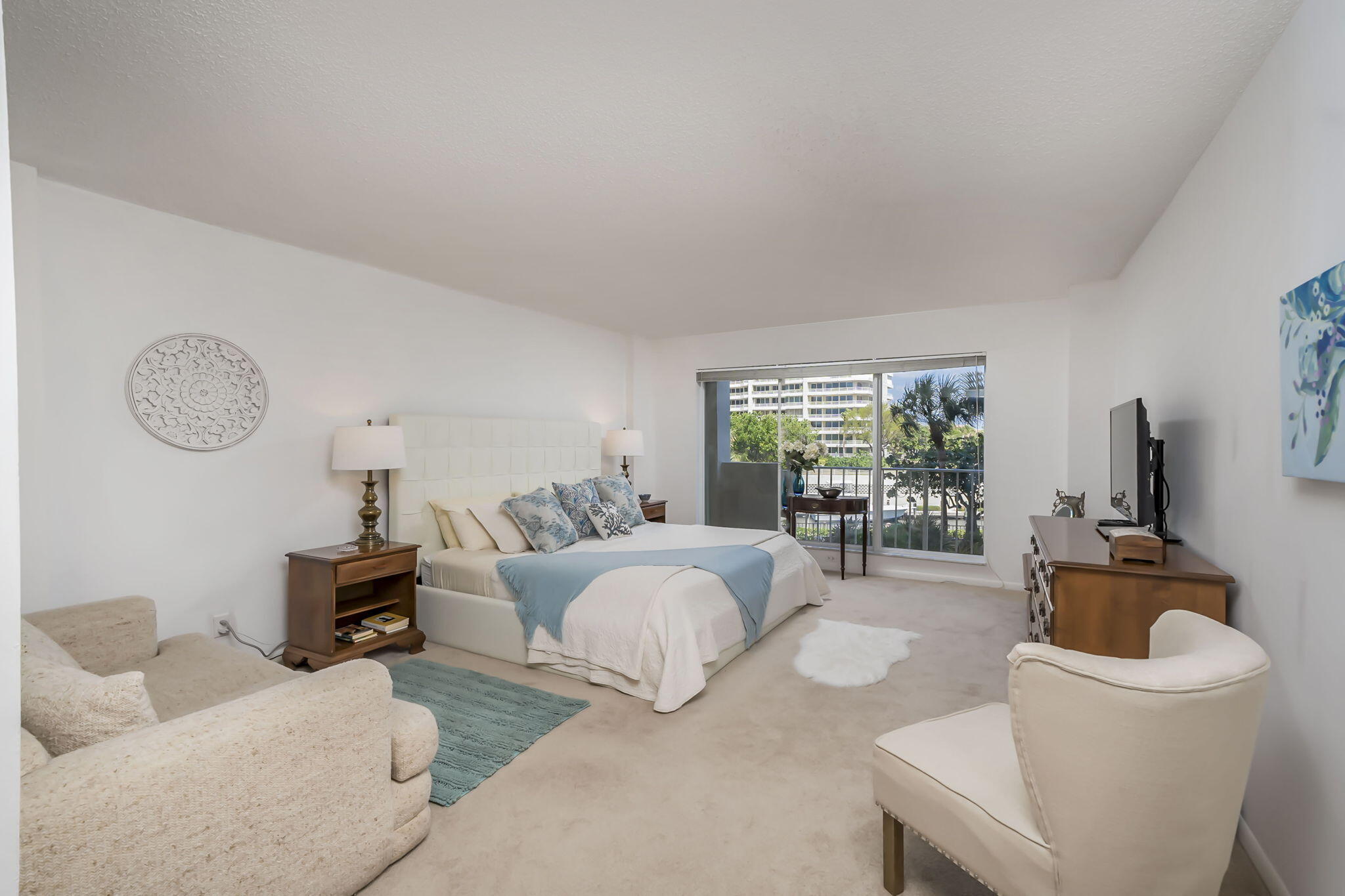 4301 North Ocean Boulevard, Unit A206 Boca Raton, FL 33431 - Photo 15 of 37 a living room with furniture a large window and a table