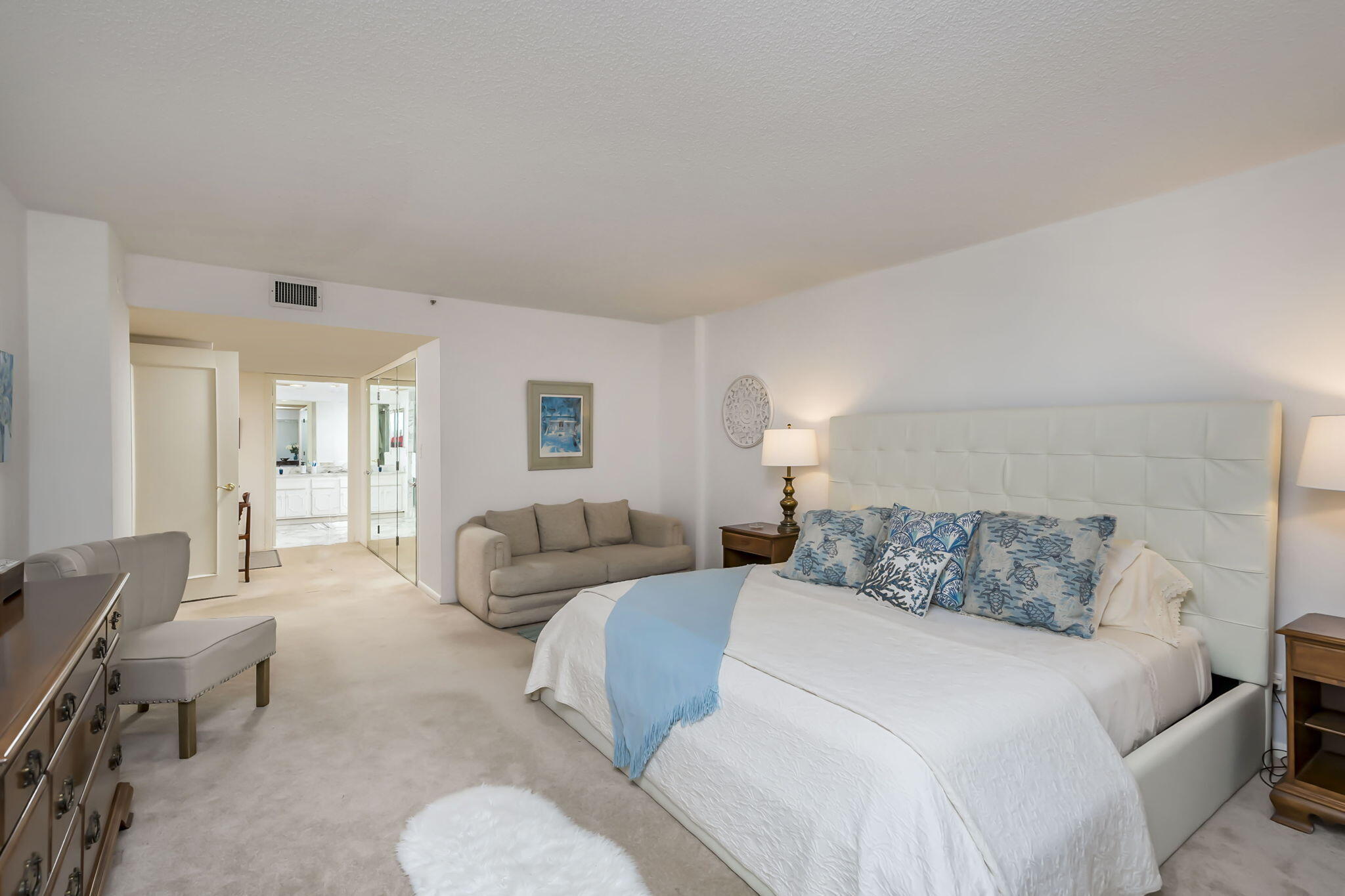 4301 North Ocean Boulevard, Unit A206 Boca Raton, FL 33431 - Photo 16 of 37 a bedroom with a bed and couch