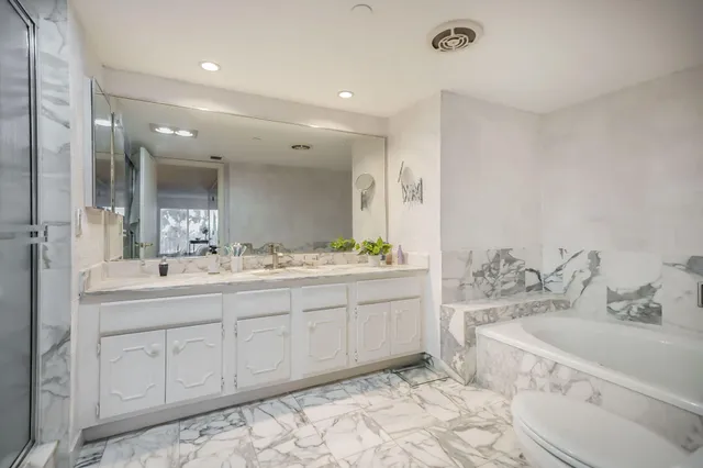 a bathroom with double vanity sink and a mirror