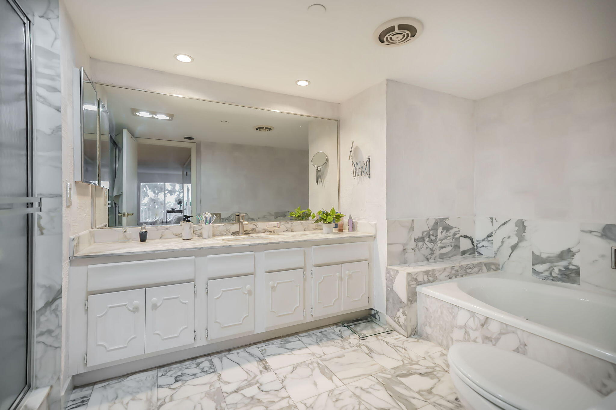 4301 North Ocean Boulevard, Unit A206 Boca Raton, FL 33431 - Photo 18 of 37 a bathroom with double vanity sink and a mirror