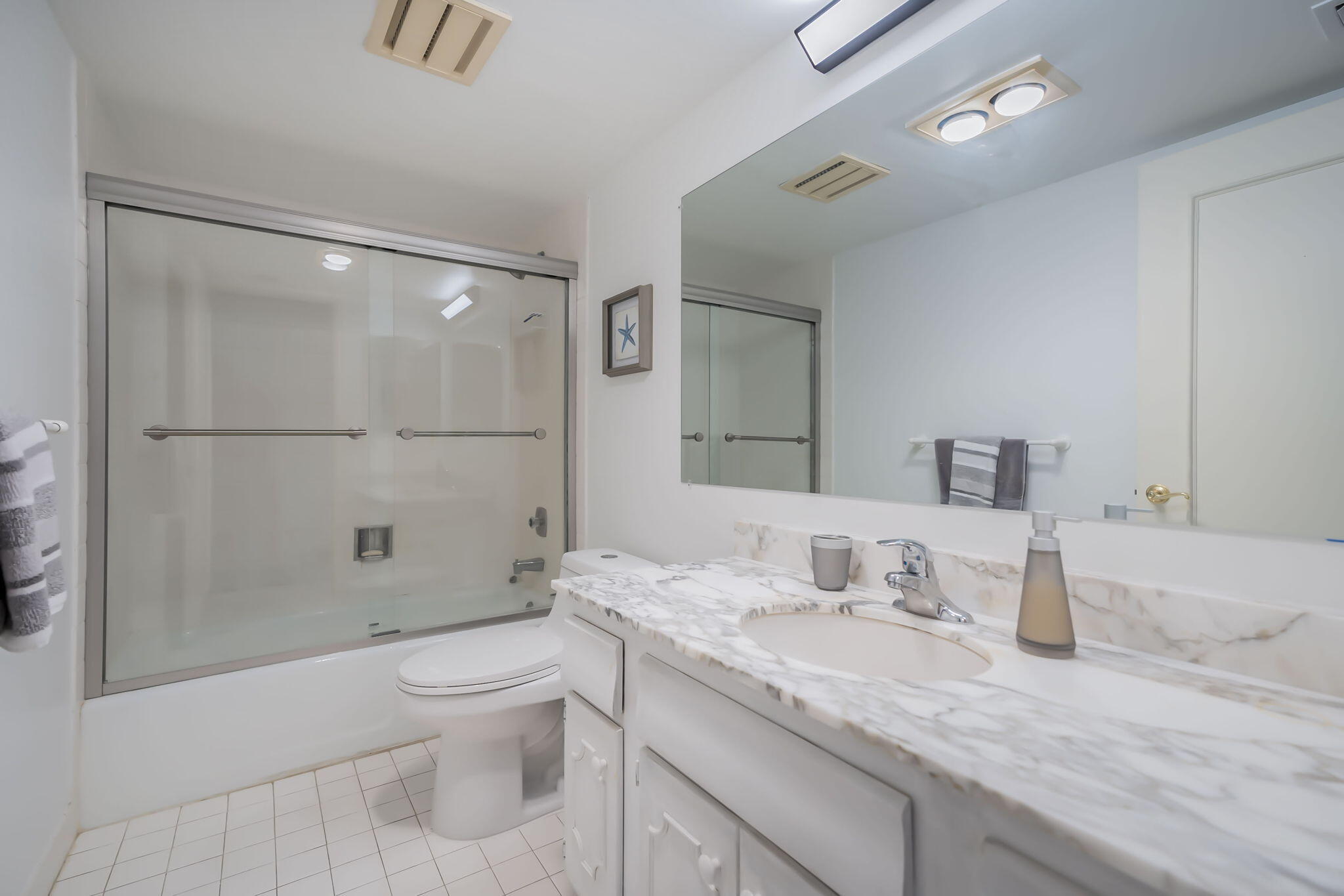 4301 North Ocean Boulevard, Unit A206 Boca Raton, FL 33431 - Photo 22 of 37 a bathroom with a granite countertop sink a toilet and shower