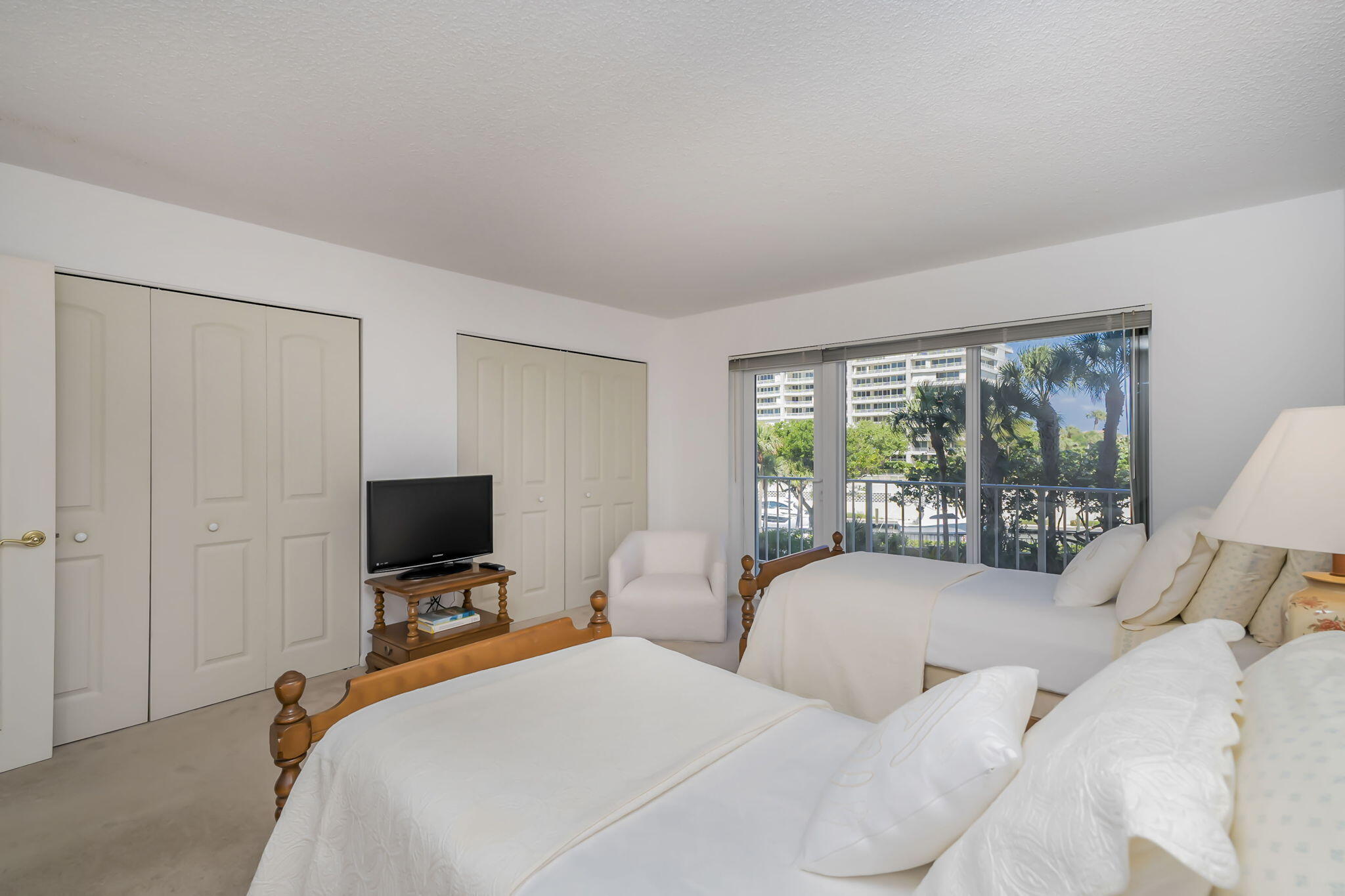 4301 North Ocean Boulevard, Unit A206 Boca Raton, FL 33431 - Photo 24 of 37 a bedroom with two beds and a flat screen tv