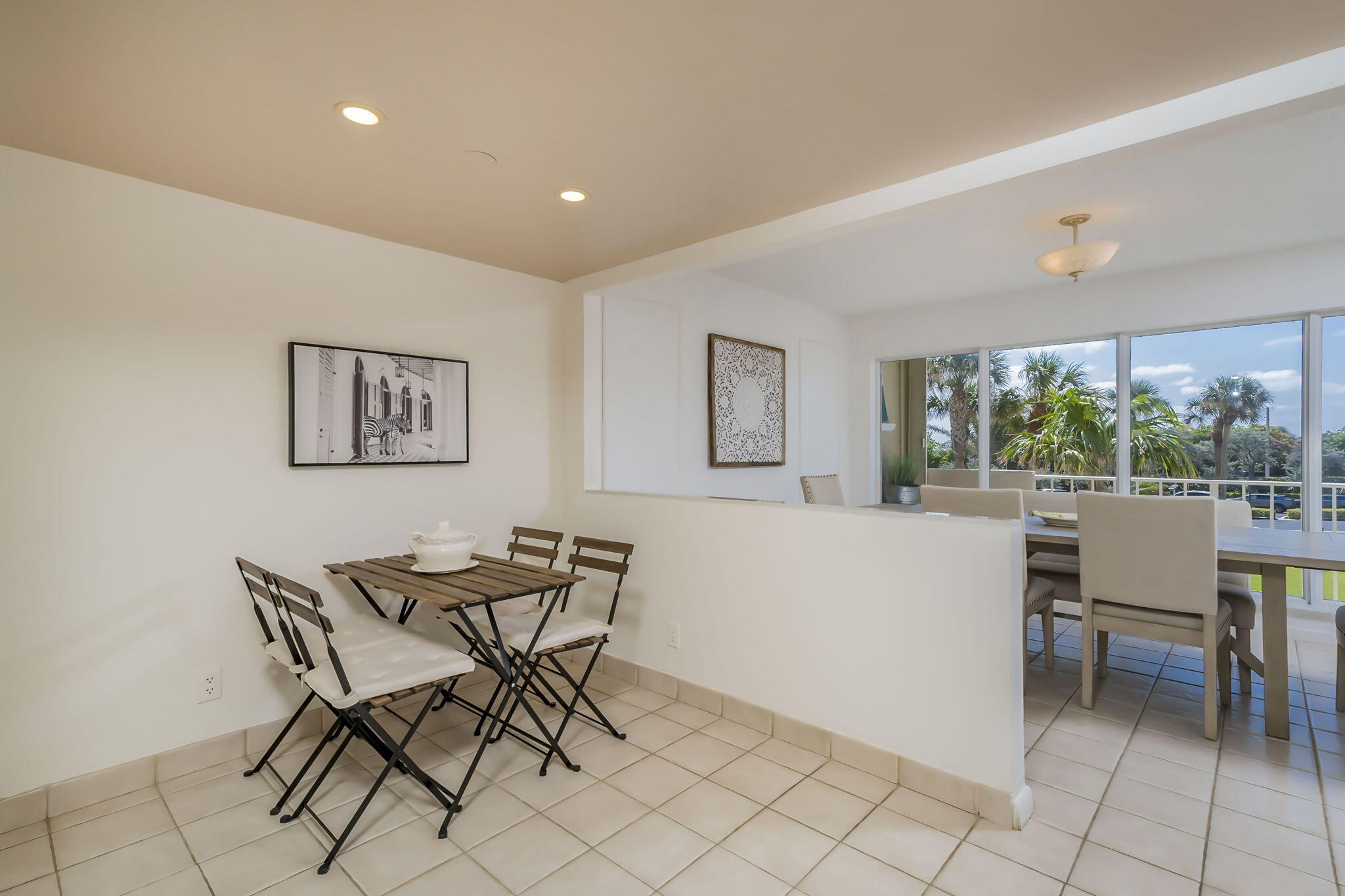 4301 North Ocean Boulevard, Unit A206 Boca Raton, FL 33431 - Photo 10 of 37 a dining room with furniture and a floor to ceiling window