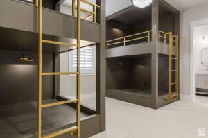 1141 East Lost Ridge Drive Washington, UT 84780 - Photo 87 of 108 Built-in bunk beds featuring a matte dark gray finish, gold-tone metal ladders, integrated lighting, and a white shuttered window