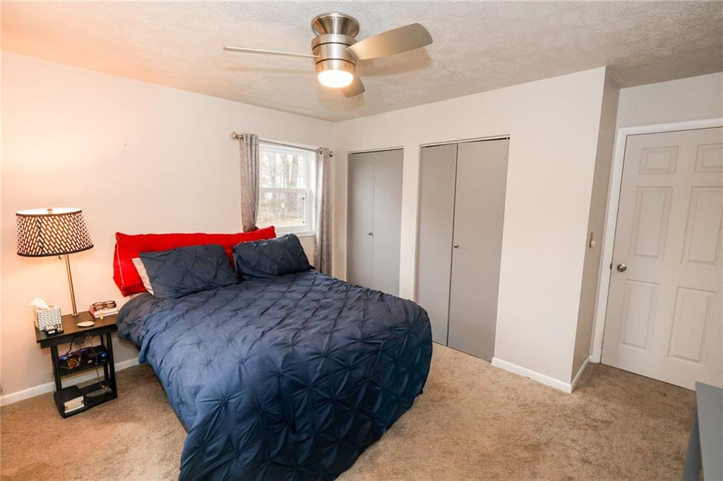 470 North Liberty Road Grove City, PA 16127 - Photo 21 of 34 a bedroom with a bed and a chandelier