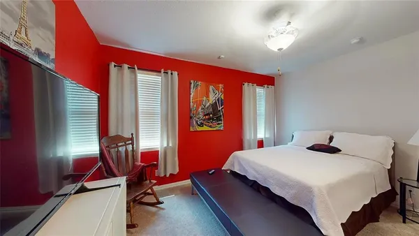 a bedroom with a bed and windows