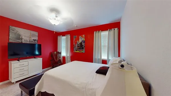 a bedroom with a bed and a flat screen tv