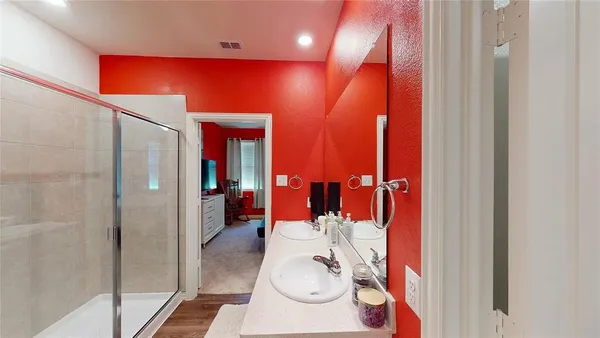 a bathroom with a shower and a glass door