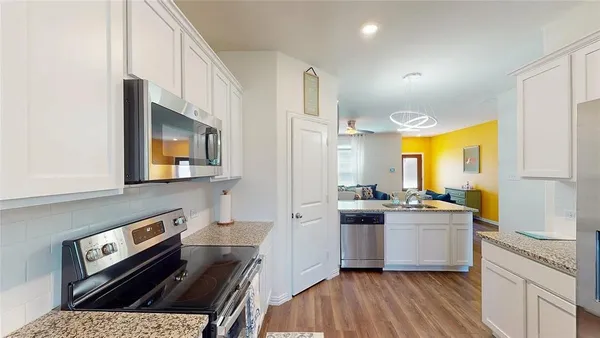 a kitchen with a stove a sink and a refrigerator