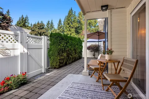 a view of a patio with table and chairs and potted plants